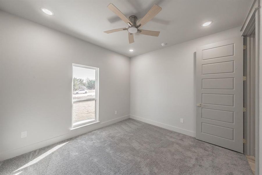 Spare room with light carpet, recessed lighting, and ceiling fan