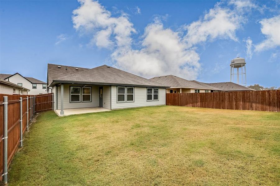 Back of house with a patio area, a fenced backyard, and roof with shingles Back of house with a patio area, a fenced backyard, and roof with shingles