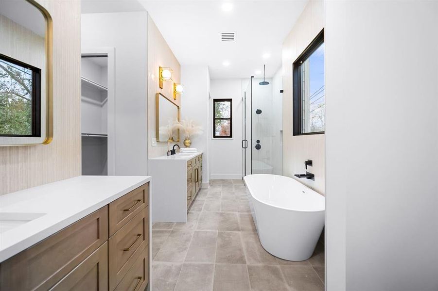 Immerse yourself in spa-like serenity in this ensuite bath, where luxurious finishes, a deep soaking tub, a walk-in shower and ambient lighting create the perfect escape for relaxation and self-care