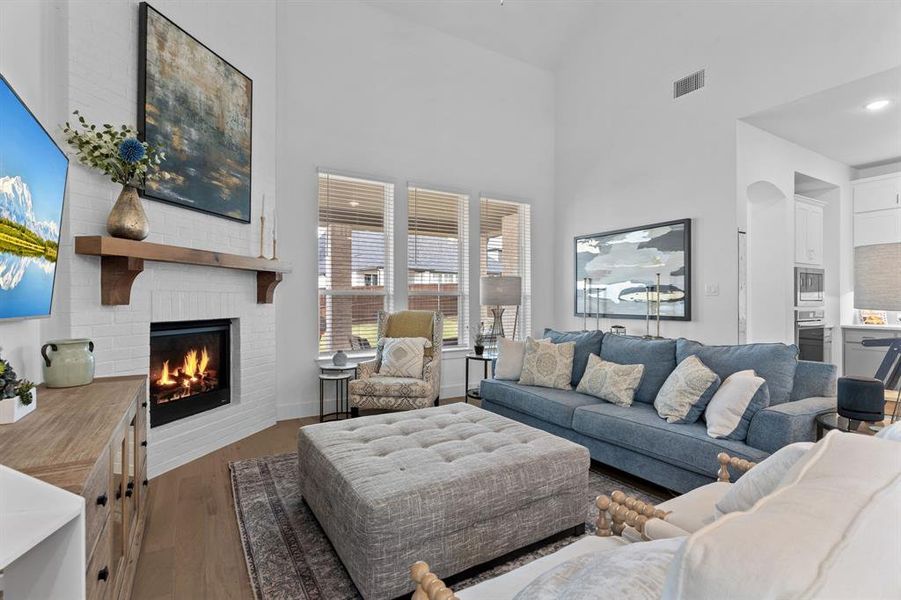 Picture yourself relaxing in this cozy living room where the floor-to-ceiling painted brick fireplace sits tucked into one corner like a quiet anchor for the space. Picture yourself relaxing in this cozy living room where the floor-to-ceiling painted brick fireplace sits tucked into one corner like a quiet anchor for the space.