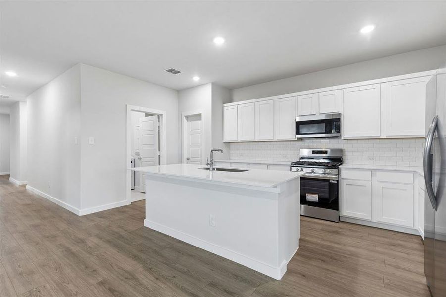 Kitchen in the Oscar home plan by Trophy Signature Homes – REPRESENTATIVE PHOTO