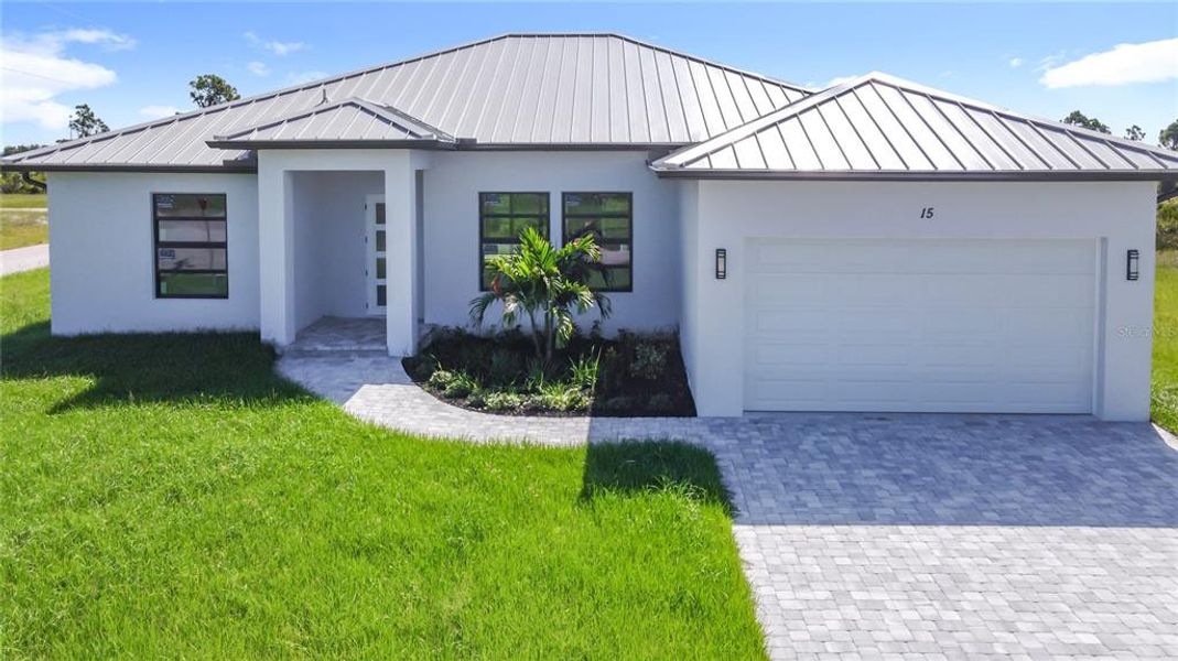 Front exterior of a new home in , Placida, FL, highlighting curb appeal (Image 2). Front exterior of a new home in , Placida, FL, highlighting curb appeal (Image 2).