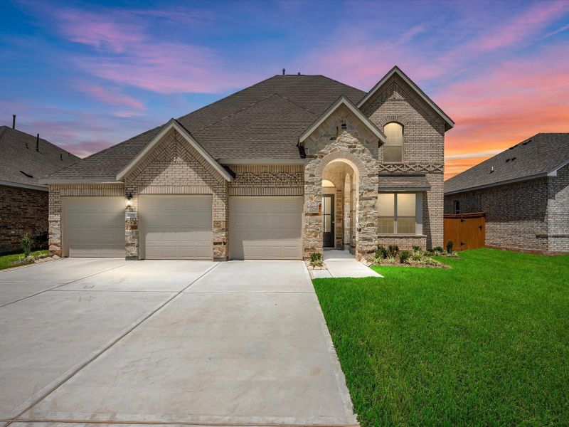 Front exterior of a new home in Sunterra Lakes, Brookshire, TX, highlighting curb appeal (Image 1). Front exterior of a new home in Sunterra Lakes, Brookshire, TX, highlighting curb appeal (Image 1).