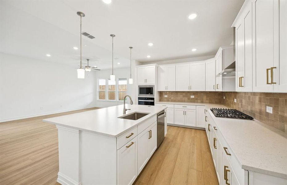 High-end gourmet kitchen with premium finishes and upgraded appliances *Real home pictured High-end gourmet kitchen with premium finishes and upgraded appliances *Real home pictured