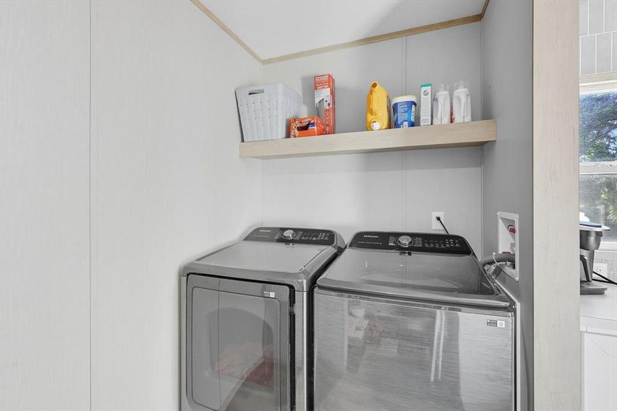 Washroom with washer and dryer and crown molding Washroom with washer and dryer and crown molding