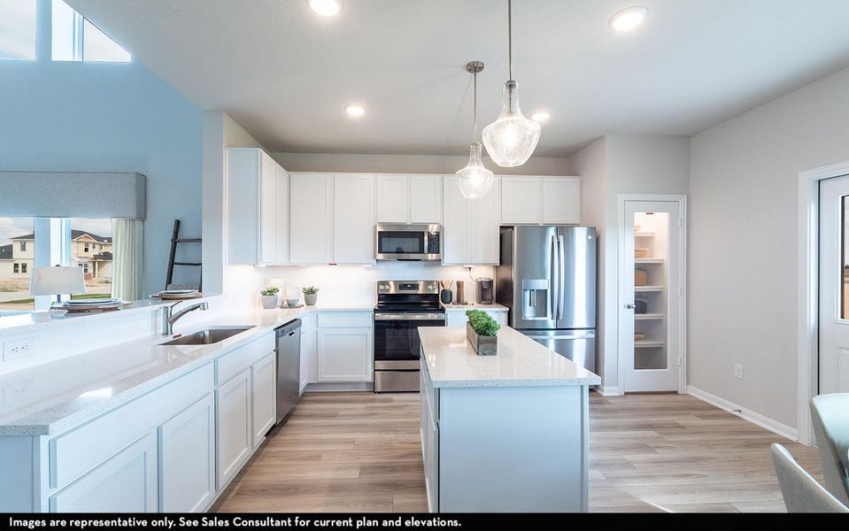 Kitchen with stainless steel appliances, white cabinetry, a center island, hanging light fixtures, and light stone counters