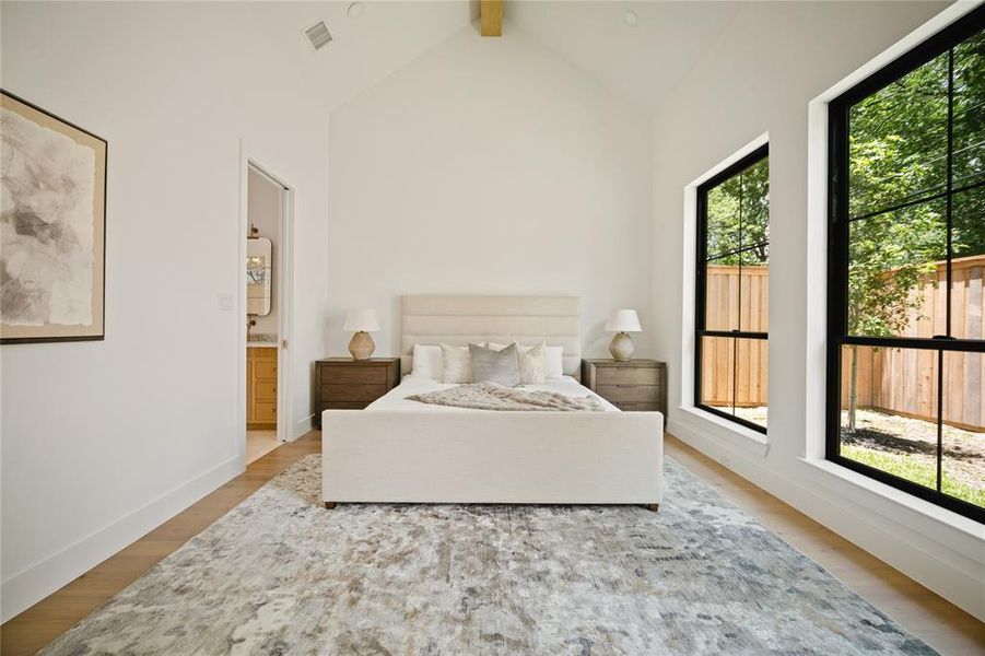 Bedroom with multiple windows and wood finished floors