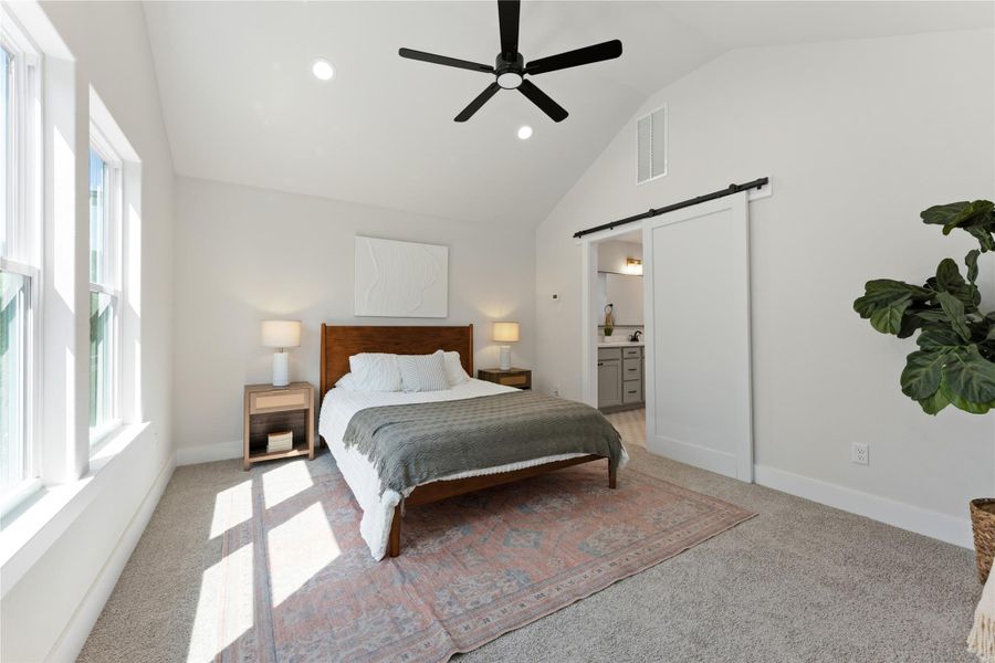 A private nest in the trees, with large windows overlooking the greenspace. Tucked upstairs as the home's only second-level room, it offers a peaceful retreat with privacy from the rest of the home.