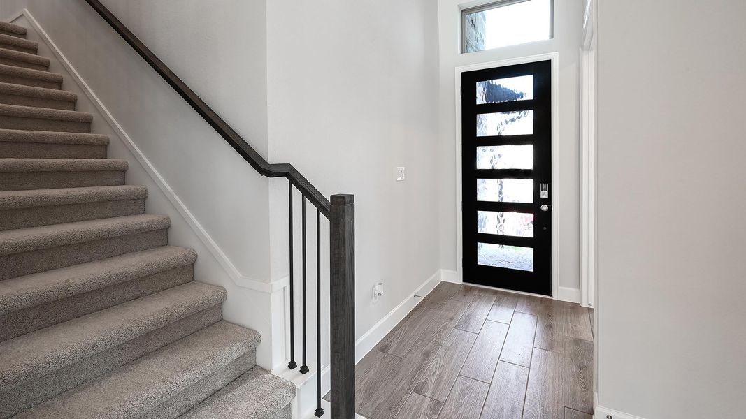 Entrance foyer featuring stairway and light wood-style flooring