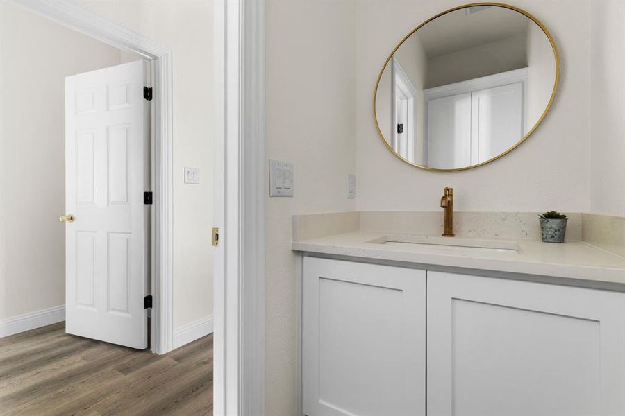 Bathroom with vanity and wood-type flooring