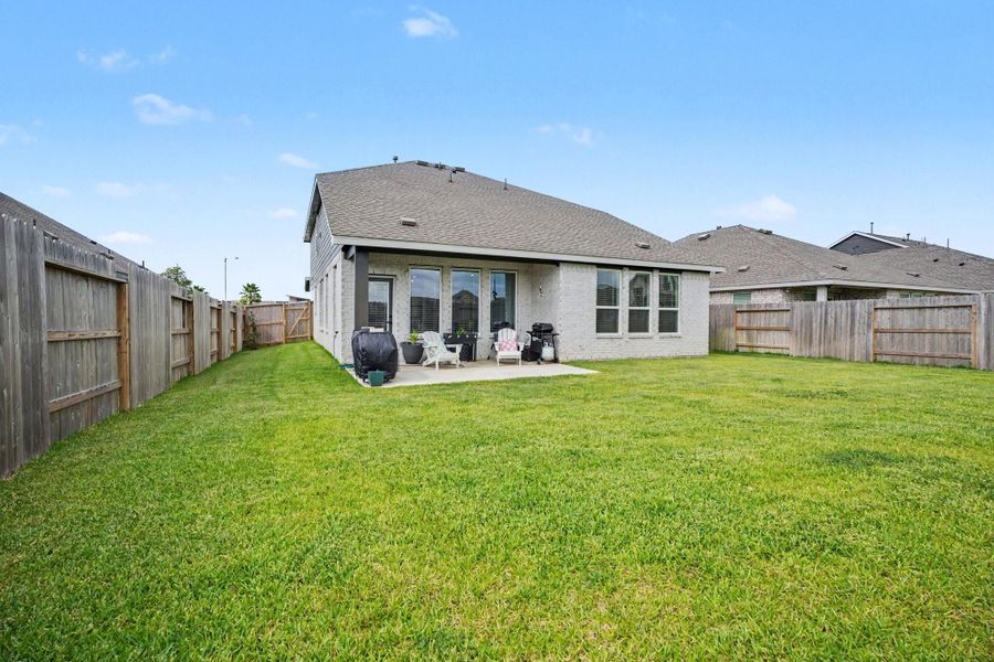 Fully fenced backyard offering plenty of green space for outdoor activities, gardening, or pets. Fully fenced backyard offering plenty of green space for outdoor activities, gardening, or pets.