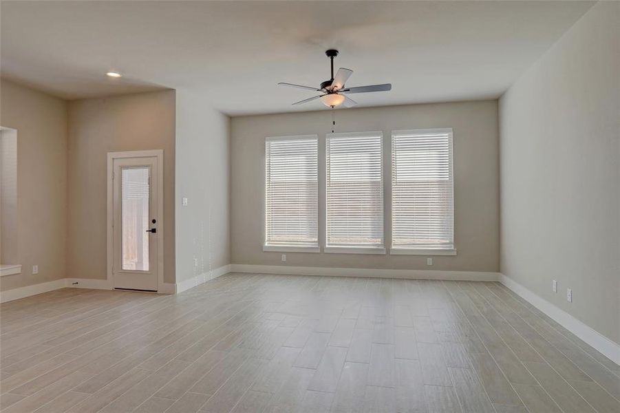 Unfurnished room featuring ceiling fan and light hardwood / wood-style floors