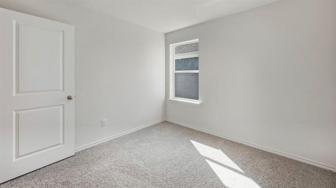 Empty room with carpet flooring and baseboards