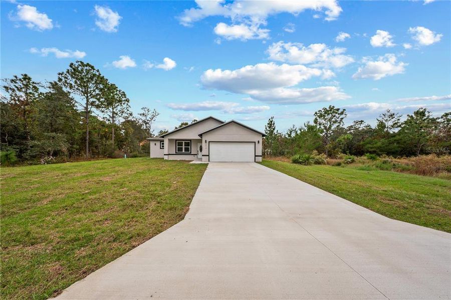 Front exterior of a new home in , Dunnellon, FL, highlighting curb appeal (Image 23).