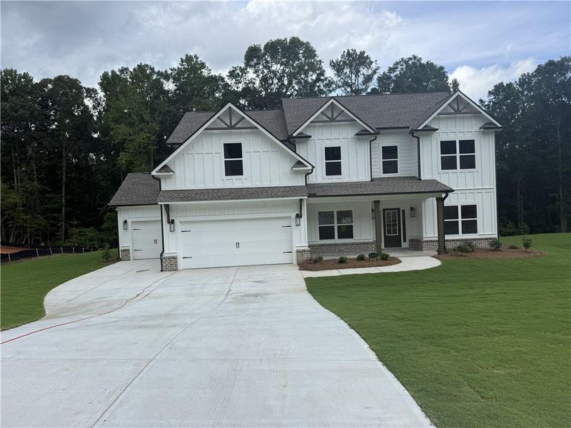 Front exterior of a new home in Woodland Hills, Loganville, GA, highlighting curb appeal (Image 1). Front exterior of a new home in Woodland Hills, Loganville, GA, highlighting curb appeal (Image 1).