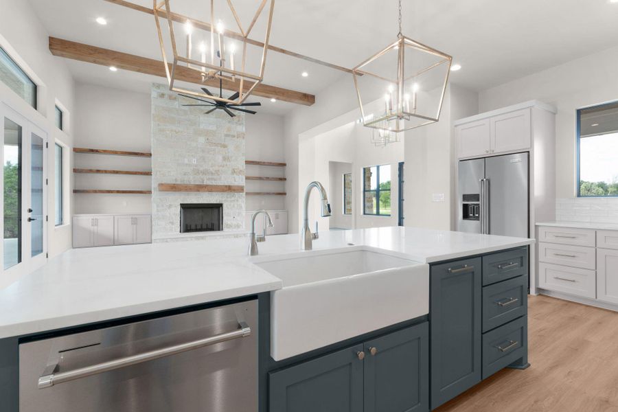 The well-appointed kitchen includes a KitchenAid appliance package, striking Quartzite countertops, custom cabinetry, and under/over-cabinet LED lighting. The well-appointed kitchen includes a KitchenAid appliance package, striking Quartzite countertops, custom cabinetry, and under/over-cabinet LED lighting.