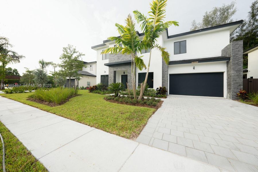 Front exterior of a new home in , Davie, FL, highlighting curb appeal (Image 1). Front exterior of a new home in , Davie, FL, highlighting curb appeal (Image 1).