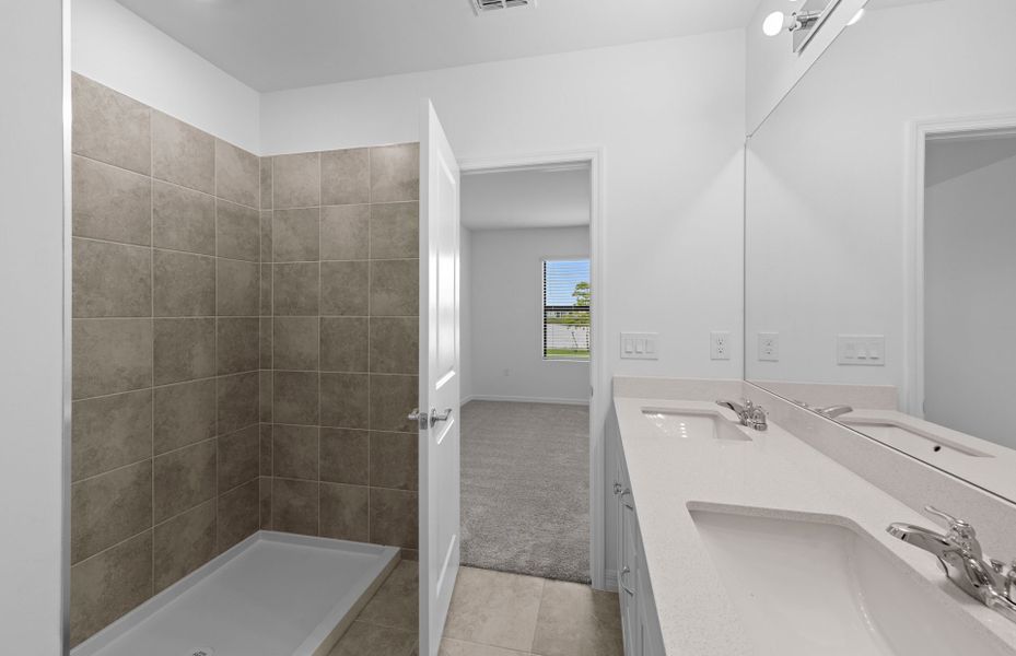 Owner's bathroom with dual-sink vanity and spacious shower Owner's bathroom with dual-sink vanity and spacious shower