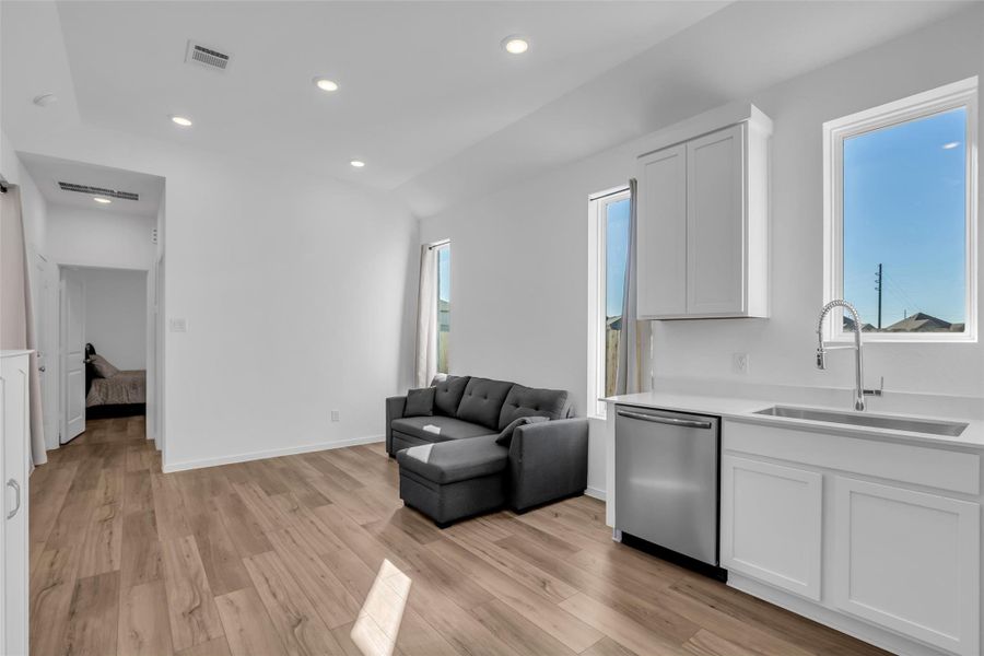 Next Gen Suite Living Space and Bedroom Entry: A bright, flexible living area with kitchenette and a dedicated bedroom straight ahead, creating a self-contained retreat with privacy and purpose. Next Gen Suite Living Space and Bedroom Entry: A bright, flexible living area with kitchenette and a dedicated bedroom straight ahead, creating a self-contained retreat with privacy and purpose.