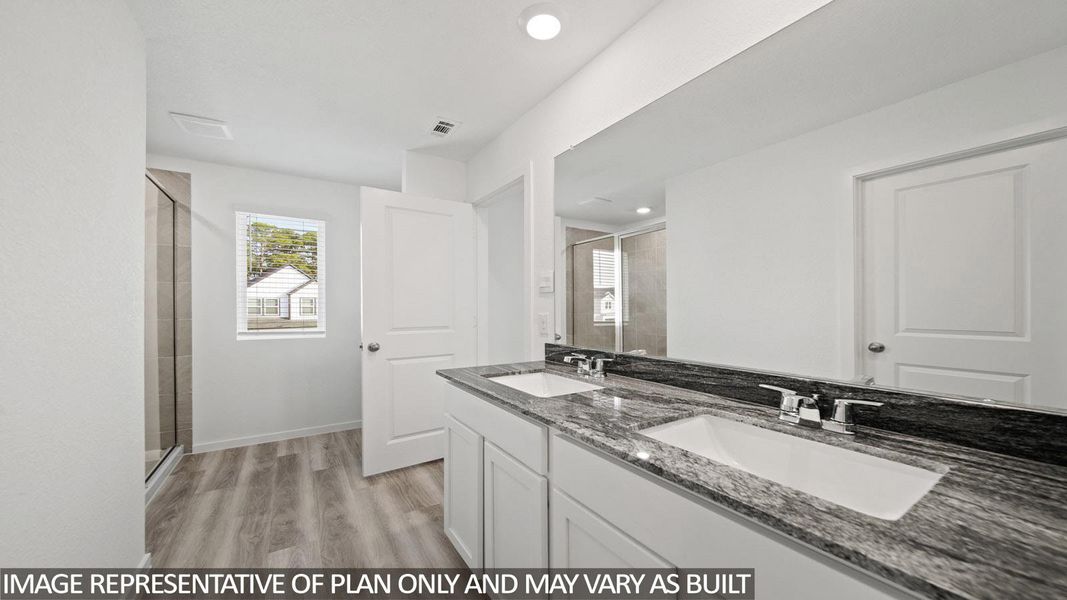 Bathroom featuring a dual vanity with a patterned countertop, integrated rectangular sinks, and chrome fixtures