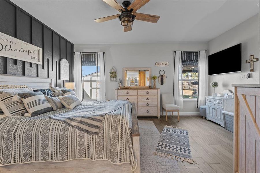 Bedroom with ceiling fan and light wood-type flooring