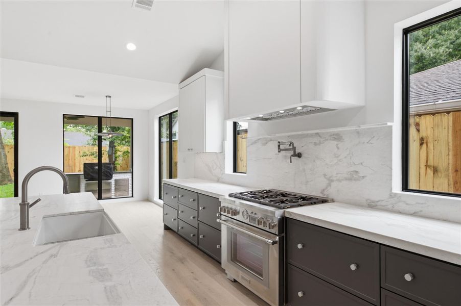 Featuring abundant prep space and designer touches throughout, this oversized kitchen island creates the ultimate entertaining space.