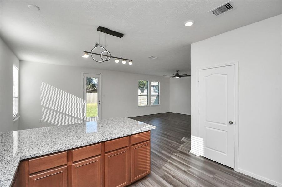 Stylish Island kitchen boasts granite counters,farm sink,stainless appliances, 42”cabinets,large walk-in pantry and open living concept.