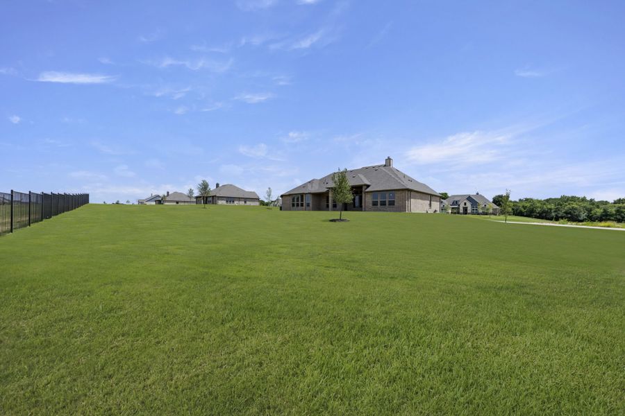 Front exterior of a new home in The Meadows, Gunter, TX, highlighting curb appeal (Image 24). Front exterior of a new home in The Meadows, Gunter, TX, highlighting curb appeal (Image 24).