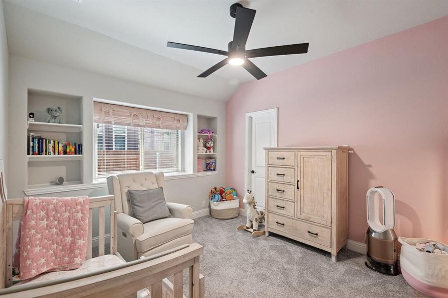Bedroom featuring light colored carpet, lofted ceiling, and ceiling fan Bedroom featuring light colored carpet, lofted ceiling, and ceiling fan