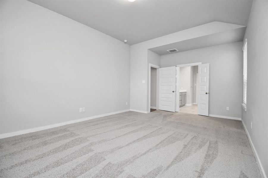 Come decompress in the stunning primary suite after a lengthy day! Experience the luxury of plush carpeting, warm paint hues, high ceilings, and large windows featuring privacy blinds. Sample photo of completed home with similar floor plan. Actual colors and selections may vary.