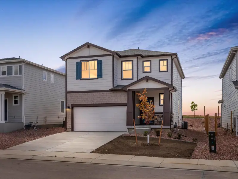 Front exterior of a new home in Lorson Ranch: The Trail Collection, Colorado Springs, CO, highlighting curb appeal (Image 1).