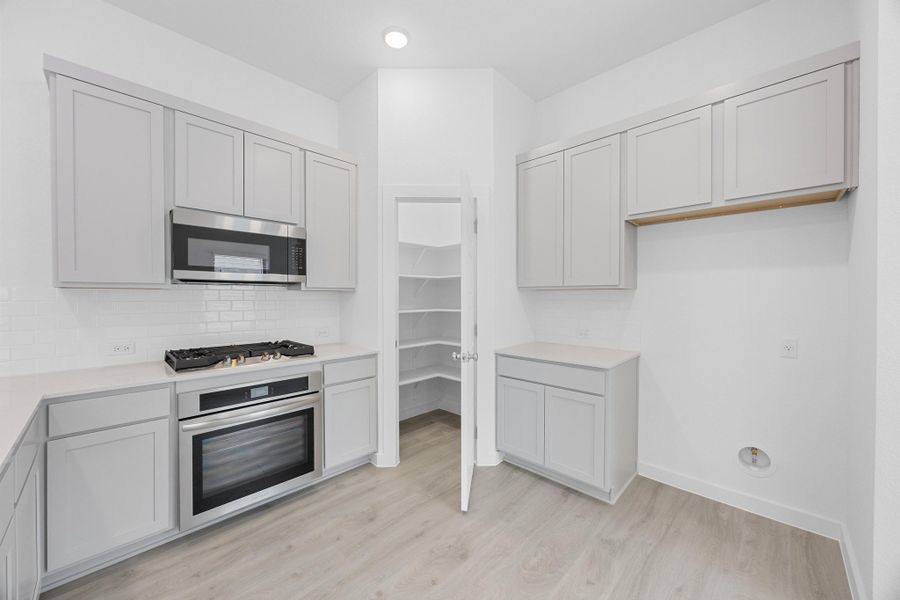 Kitchen in the Pecan II home plan by Trophy Signature Homes – REPRESENTATIVE PHOTO Kitchen in the Pecan II home plan by Trophy Signature Homes – REPRESENTATIVE PHOTO