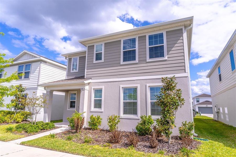 Front exterior of a new home in , St. Cloud, FL, highlighting curb appeal (Image 28).