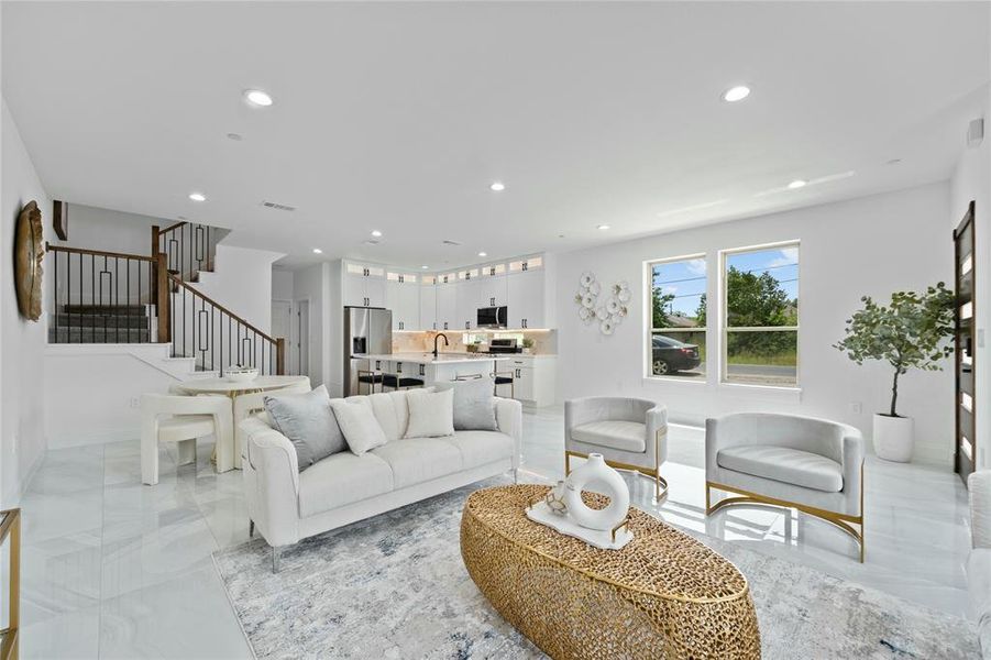 Living room with recessed lighting, stairway, and light marble finish floors