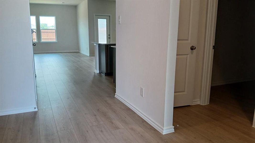 Light wood-finish flooring throughout, complemented by white baseboards and neutral wall tones Light wood-finish flooring throughout, complemented by white baseboards and neutral wall tones