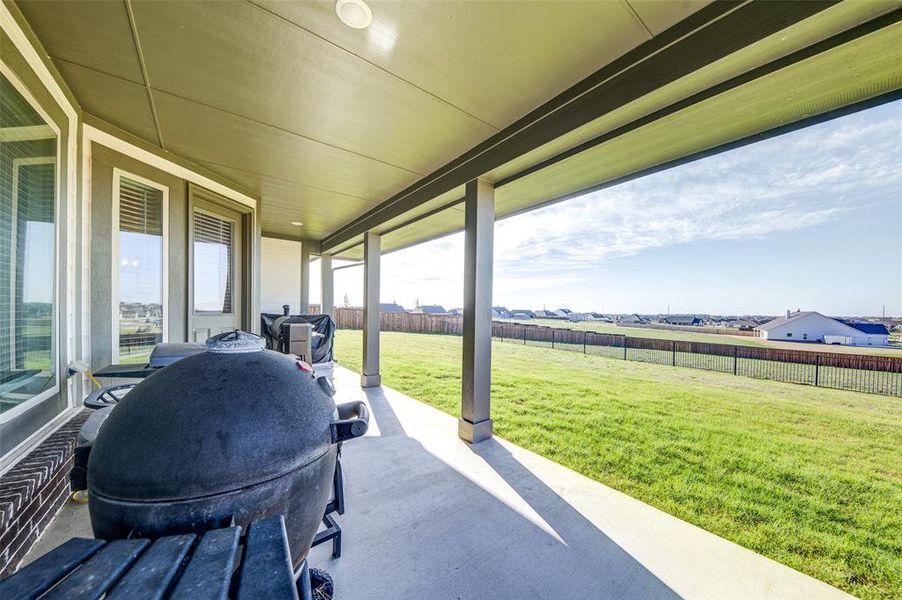 Fenced backyard featuring a patio area and a residential view