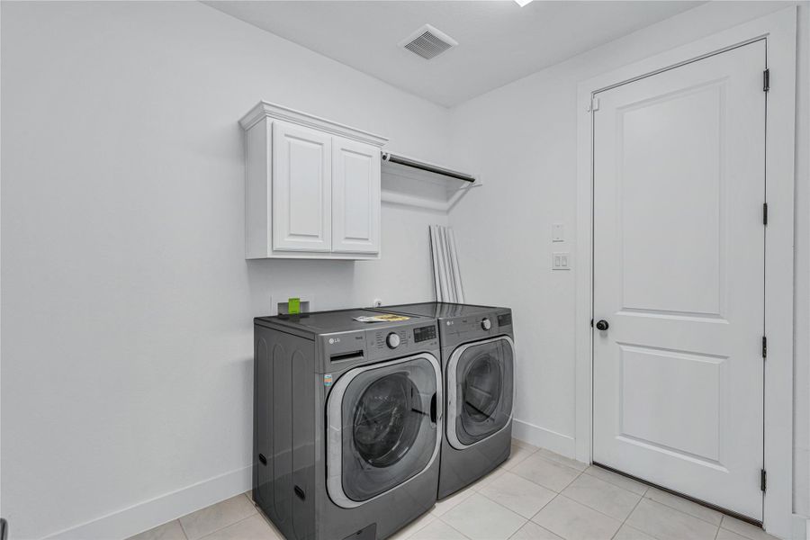 Functional utility room featuring integrated storage and tiled flooring.