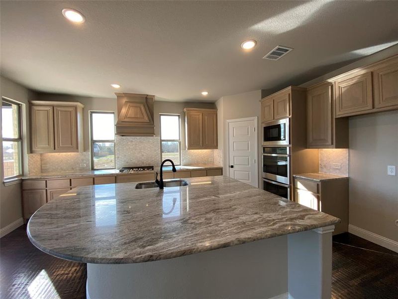 Gourmet kitchen with Champagne cabinets,decorative mosaic tile backsplash, and Fanasy Brown granite counters Gourmet kitchen with Champagne cabinets,decorative mosaic tile backsplash, and Fanasy Brown granite counters
