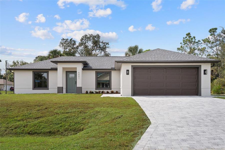 Front exterior of a new home in , North Port, FL, highlighting curb appeal (Image 1). Front exterior of a new home in , North Port, FL, highlighting curb appeal (Image 1).