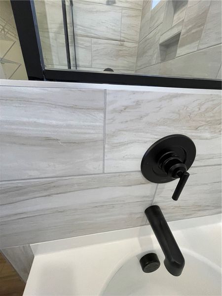 This sleek bathroom features elegant tile work and