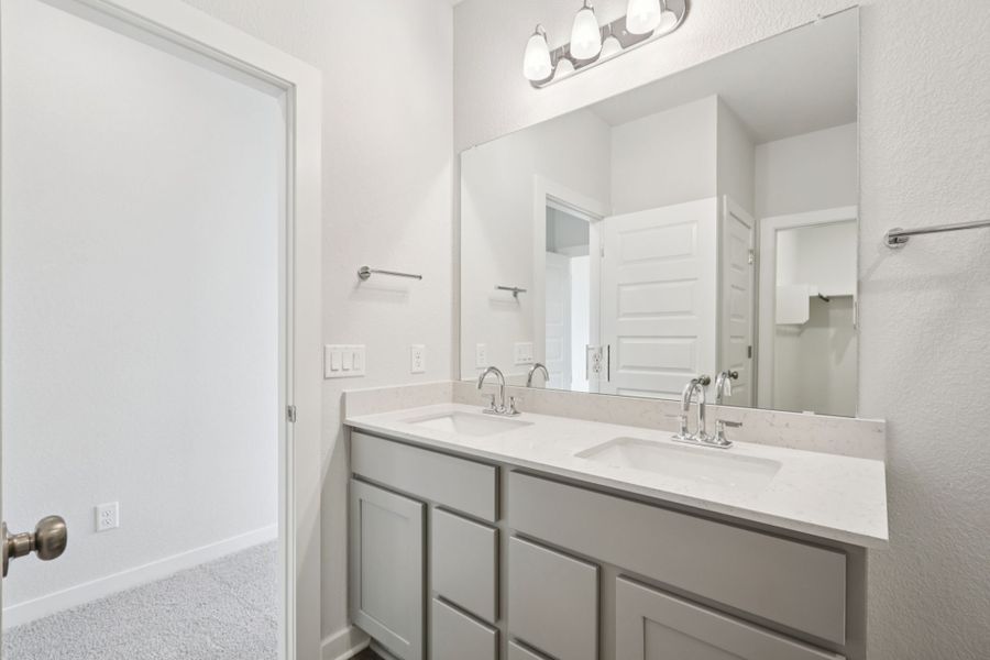 A bathroom with a large mirror.