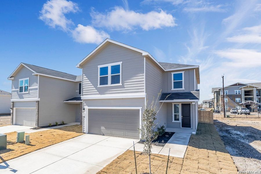 Front exterior of a new home in Medina Crossing, Von Ormy, TX, highlighting curb appeal (Image 1). Front exterior of a new home in Medina Crossing, Von Ormy, TX, highlighting curb appeal (Image 1).