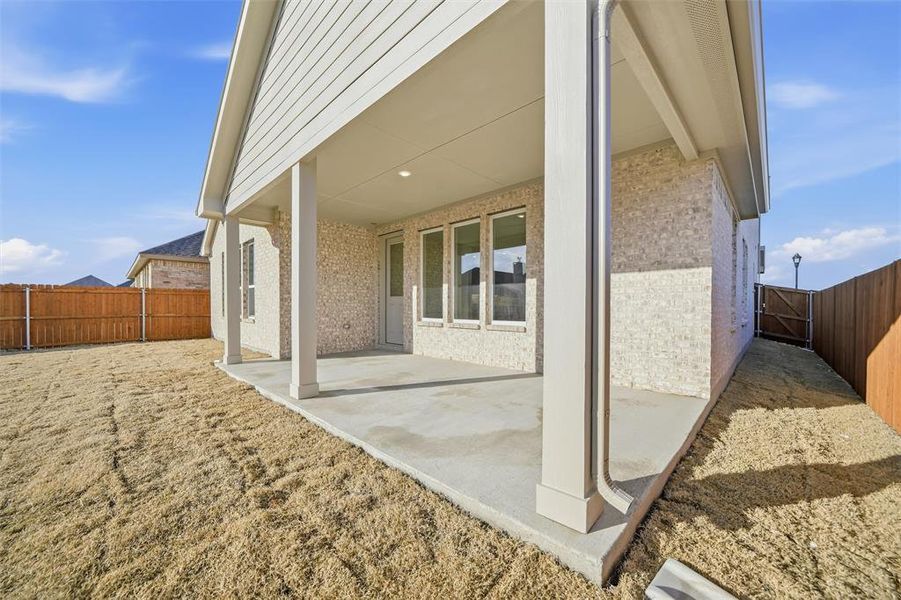 Fenced backyard with a patio area Fenced backyard with a patio area