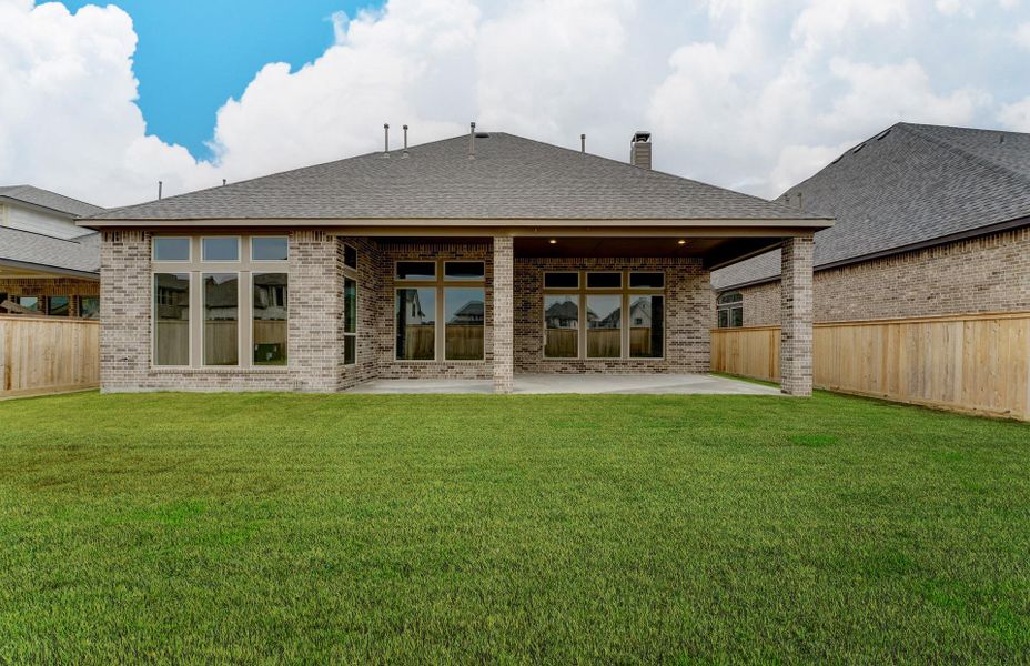 Exterior details and patio area of a home in The Woodlands Hills 65′, Willis (Image 25).