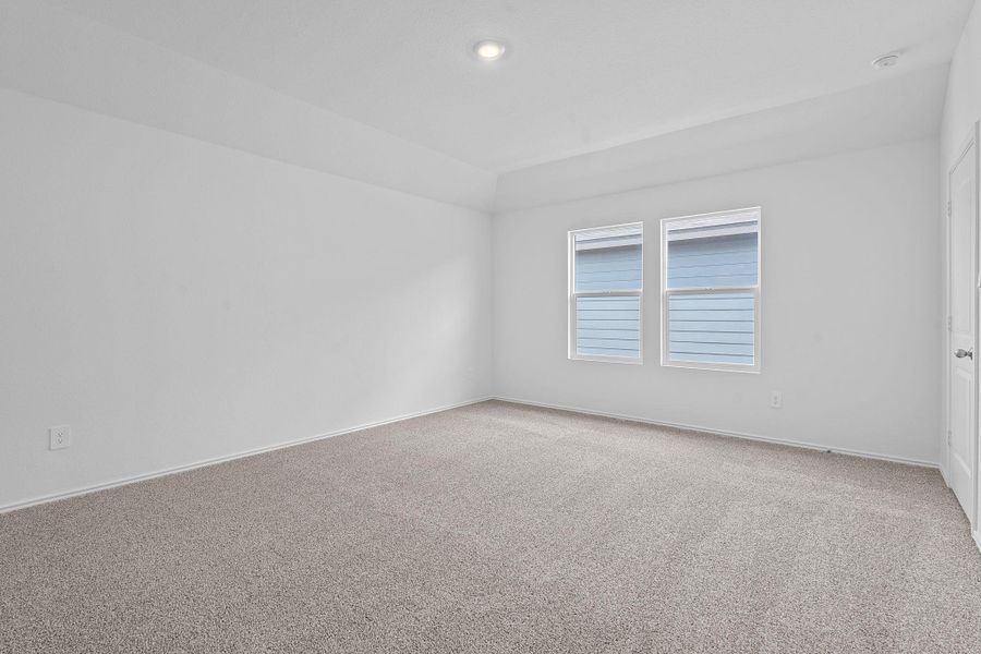 Carpeted empty room featuring baseboards and recessed lighting Carpeted empty room featuring baseboards and recessed lighting