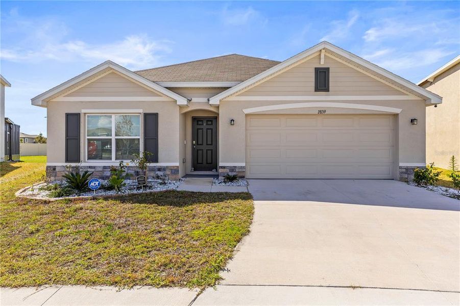 Front exterior of a new home in Berry Bay, Wimauma, FL, highlighting curb appeal (Image 24). Front exterior of a new home in Berry Bay, Wimauma, FL, highlighting curb appeal (Image 24).