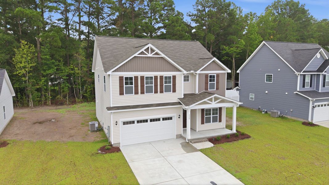 Front exterior of a new home in Davenport Farms, Winterville, NC, highlighting curb appeal (Image 21). Front exterior of a new home in Davenport Farms, Winterville, NC, highlighting curb appeal (Image 21).