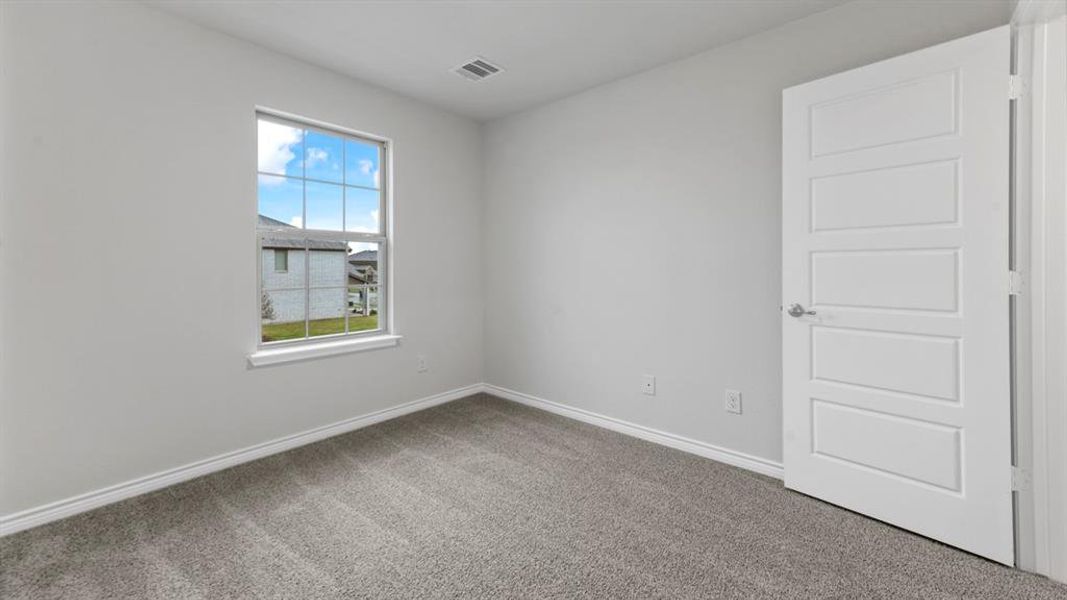 Room featuring light gray carpet, white baseboards, and a single window with white trim