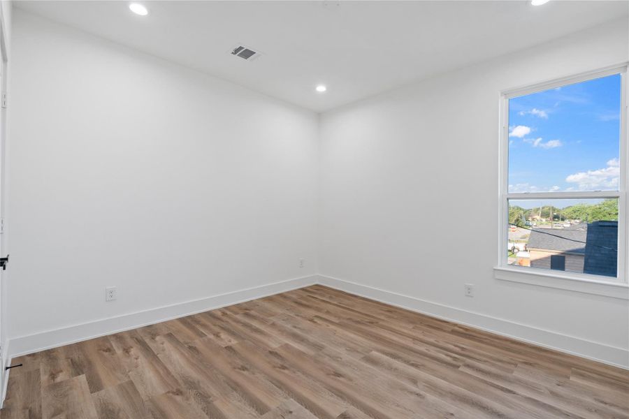 The primary bedroom is generously sized, offering plenty of room for relaxation and personal retreat. Its spacious layout enhances comfort and allows for versatile furniture arrangements. This airy, open design creates a serene and inviting atmosphere.