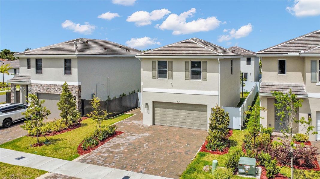 Front exterior of a new home in Messina Place, Homestead, FL, highlighting curb appeal (Image 26). Front exterior of a new home in Messina Place, Homestead, FL, highlighting curb appeal (Image 26).